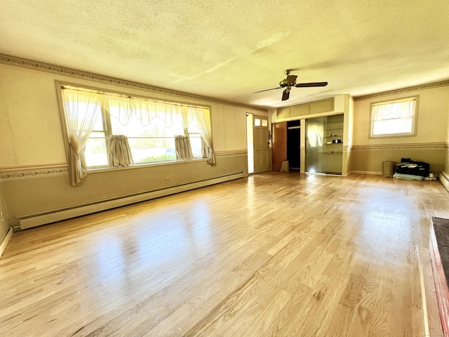343 Lebanon Ave, Lebanon, CT 06249 - unfurnished living room with a baseboard heating unit, a textured ceiling, light wood finished floors, and a ceiling fan