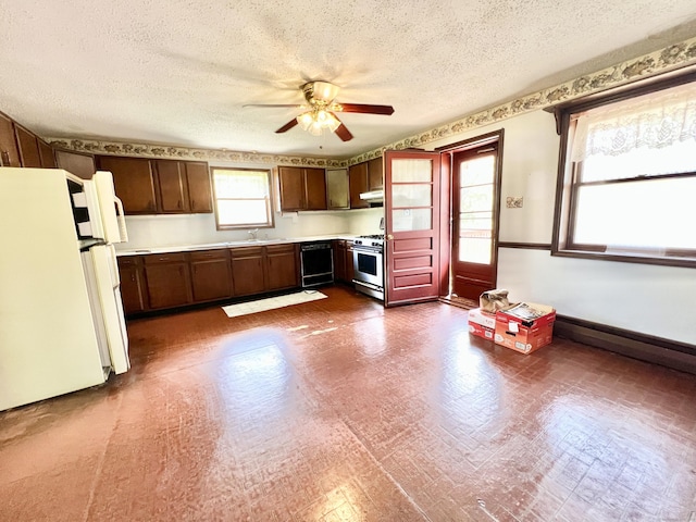 343 Lebanon Ave, Lebanon, CT 06249 - kitchen featuring freestanding refrigerator, stainless steel range with gas stovetop, black dishwasher, ceiling fan, and light countertops