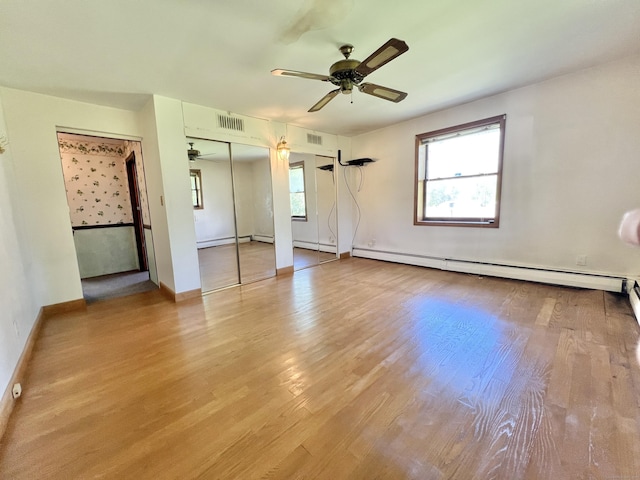 343 Lebanon Ave, Lebanon, CT 06249 - unfurnished bedroom featuring multiple windows, a baseboard radiator, baseboards, and wood finished floors