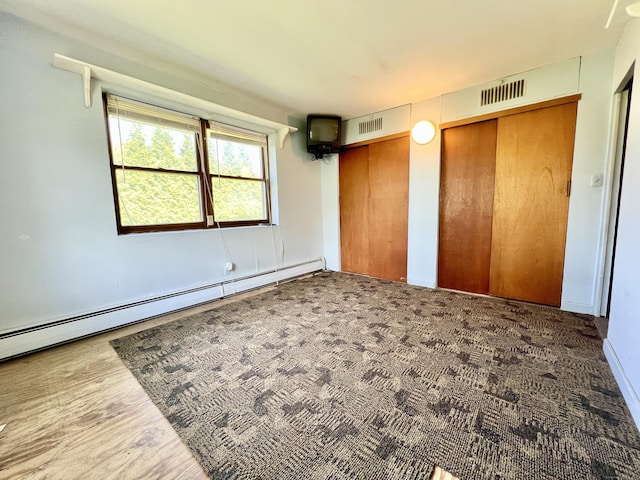 343 Lebanon Ave, Lebanon, CT 06249 - unfurnished bedroom featuring multiple closets and baseboard heating