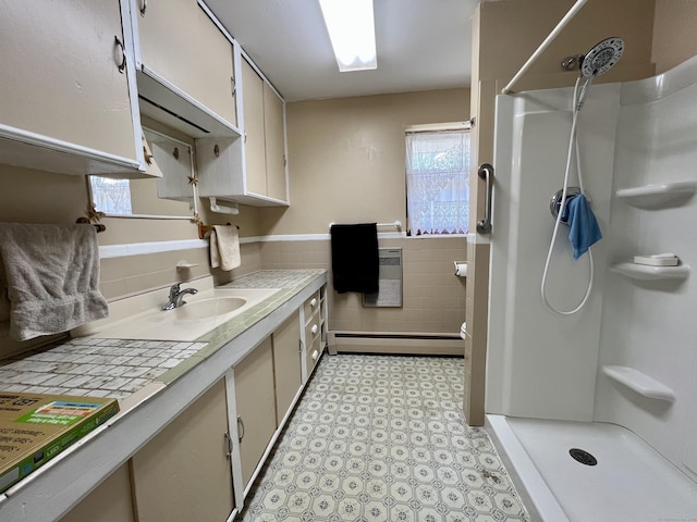 343 Lebanon Ave, Lebanon, CT 06249 - full bath with a baseboard heating unit, a shower stall, tile walls, vanity, and wainscoting