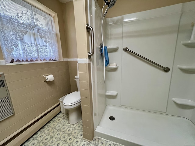343 Lebanon Ave, Lebanon, CT 06249 - bathroom featuring tile walls, a baseboard radiator, toilet, a shower stall, and tile patterned floors