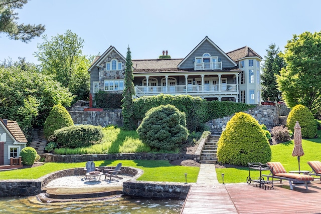 55 Lake Dr S, New Fairfield, CT 06812 - back of property featuring a fire pit, stairway, and a lawn