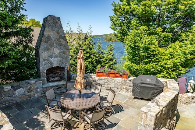 55 Lake Dr S, New Fairfield, CT 06812 - view of patio / terrace with an outdoor stone fireplace, grilling area, a water view, and outdoor dining area