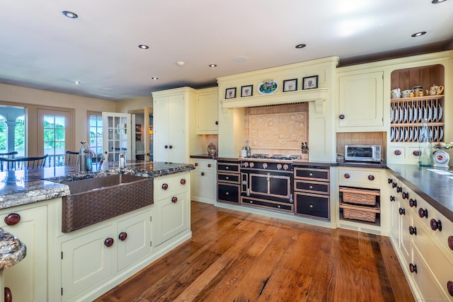55 Lake Dr S, New Fairfield, CT 06812 - kitchen with a sink, wood finished floors, backsplash, dark stone countertops, and recessed lighting