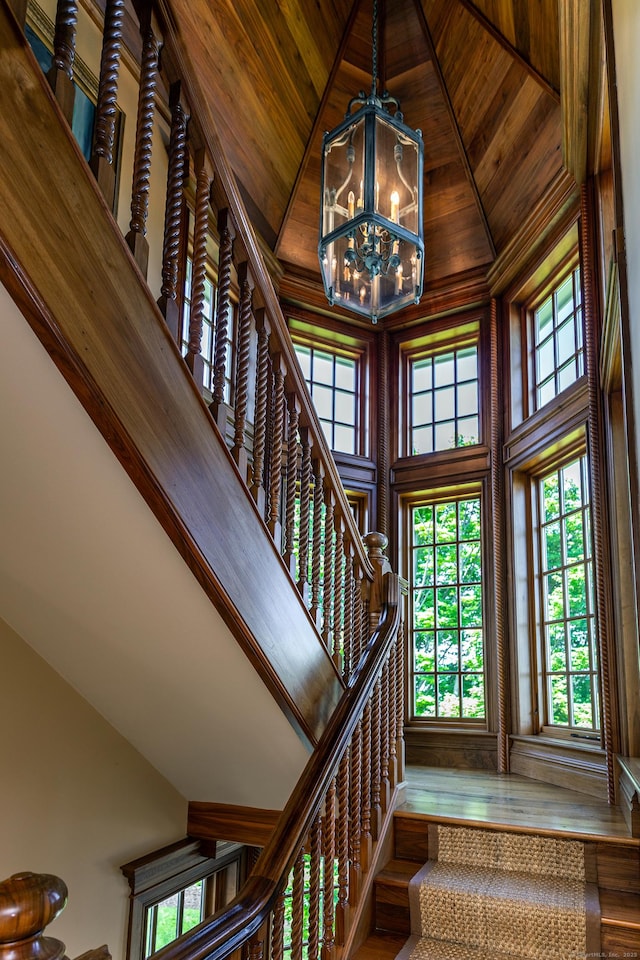 55 Lake Dr S, New Fairfield, CT 06812 - stairway with a chandelier, high vaulted ceiling, wooden ceiling, and wood finished floors