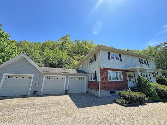 5 Yochers Ln, Derby, CT 06418 - view of front of home featuring decorative driveway, a garage, and brick siding