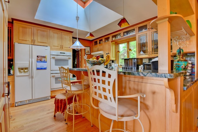 5 Yochers Ln, Derby, CT 06418 - kitchen featuring white appliances, light wood finished floors, a breakfast bar area, glass insert cabinets, and hanging light fixtures