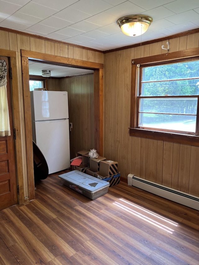 1092 Plainfield Pike, Sterling, CT 06373 - unfurnished room with ornamental molding, wood finished floors, wood walls, and a baseboard radiator