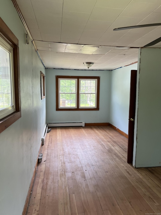 1092 Plainfield Pike, Sterling, CT 06373 - unfurnished room featuring baseboard heating, wood-type flooring, and baseboards