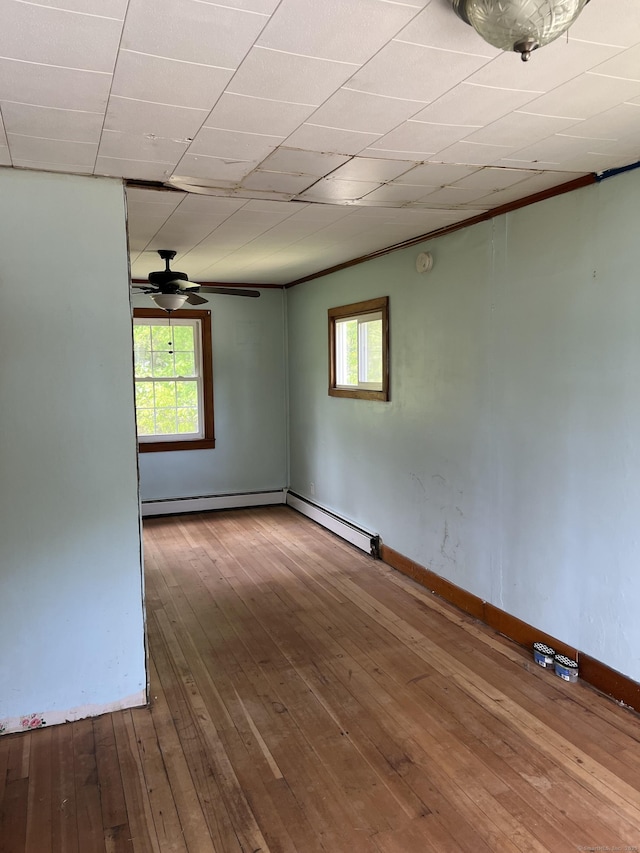 1092 Plainfield Pike, Sterling, CT 06373 - spare room with plenty of natural light, a baseboard radiator, ceiling fan, and hardwood / wood-style flooring