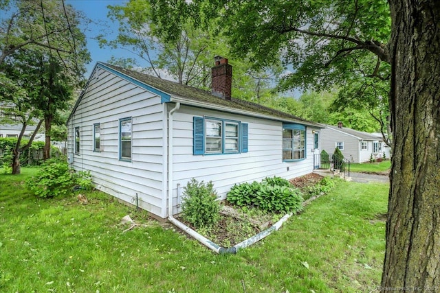 1 Triangle Ter, Danbury, CT 06810 - view of property exterior featuring a chimney and a lawn