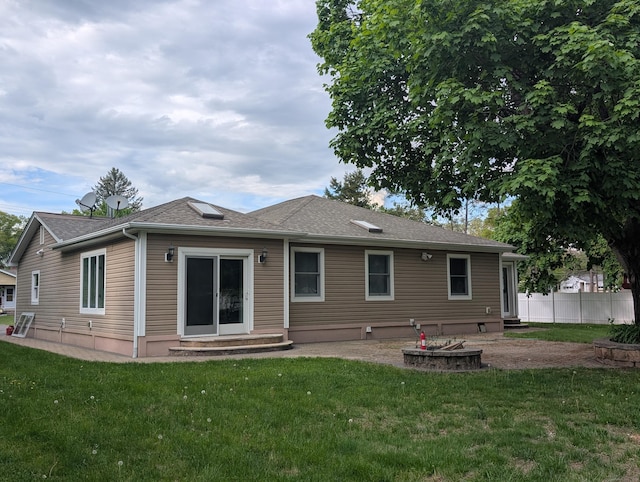 back of house featuring entry steps and roof with shingles