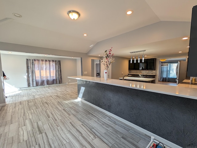 9 Washington Rd, Windsor, CT 06095 - kitchen with lofted ceiling, freestanding refrigerator, light countertops, recessed lighting, and decorative backsplash