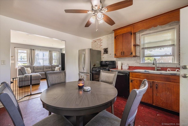 dining space featuring plenty of natural light, a ceiling fan, and dark wood finished floors