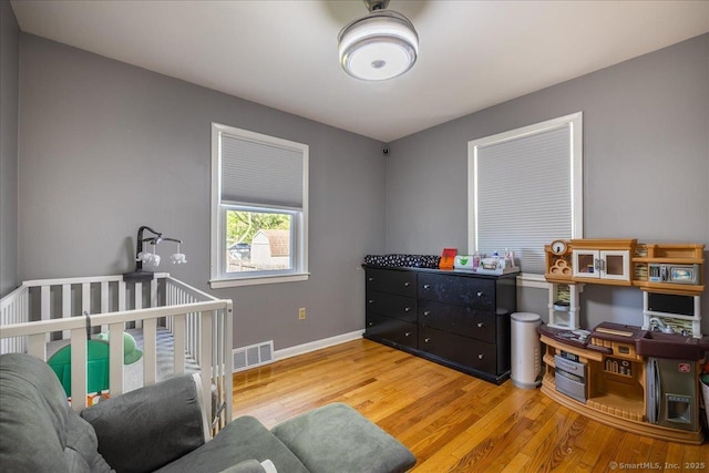 bedroom with wood finished floors and baseboards