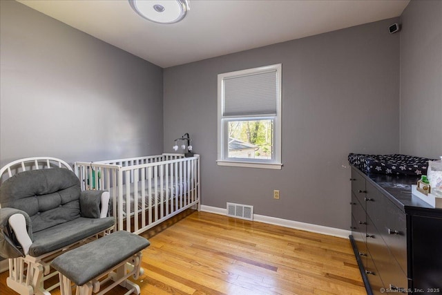 bedroom with light wood-style floors and baseboards