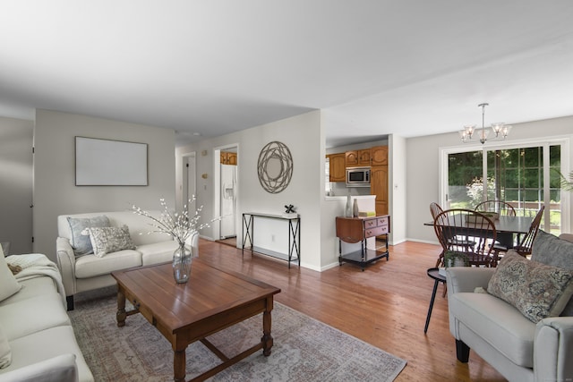 27 Scudder Rd, Newtown, CT 06470 - living area featuring a chandelier, wood finished floors, and baseboards