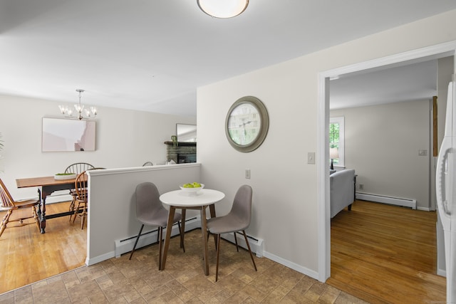 27 Scudder Rd, Newtown, CT 06470 - dining room with a baseboard heating unit, a chandelier, and baseboards