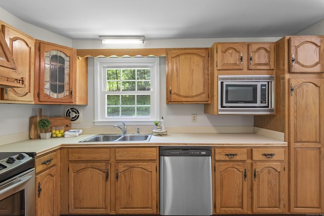 27 Scudder Rd, Newtown, CT 06470 - kitchen with appliances with stainless steel finishes, a sink, light countertops, and brown cabinets