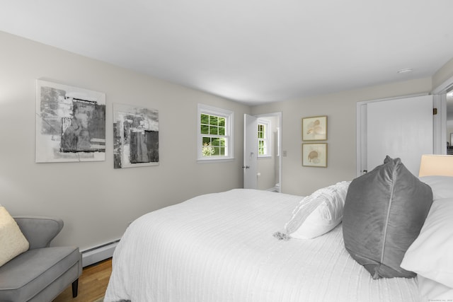 27 Scudder Rd, Newtown, CT 06470 - bedroom with baseboard heating and wood finished floors