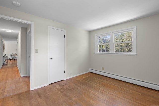 27 Scudder Rd, Newtown, CT 06470 - unfurnished bedroom featuring baseboard heating, light wood-style floors, and baseboards