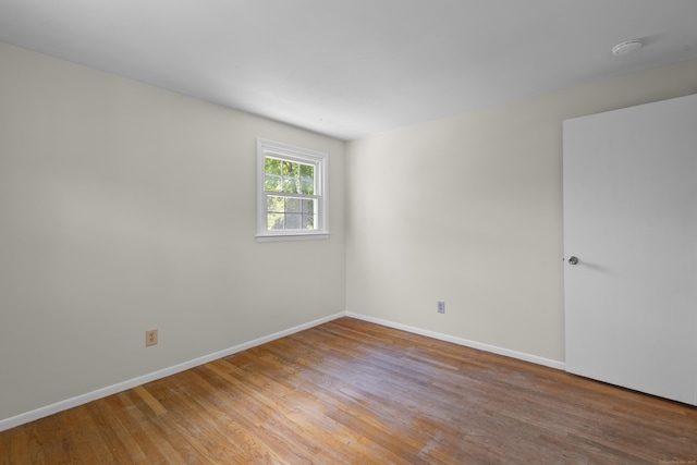 27 Scudder Rd, Newtown, CT 06470 - empty room with light wood-type flooring, baseboards, and a smoke detector