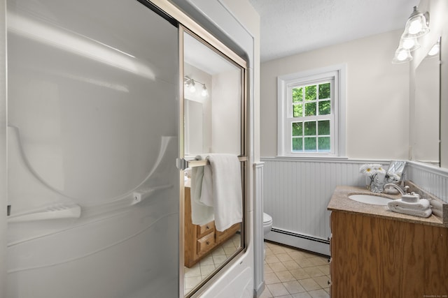 27 Scudder Rd, Newtown, CT 06470 - full bath featuring baseboard heating, wainscoting, vanity, toilet, and tile patterned flooring