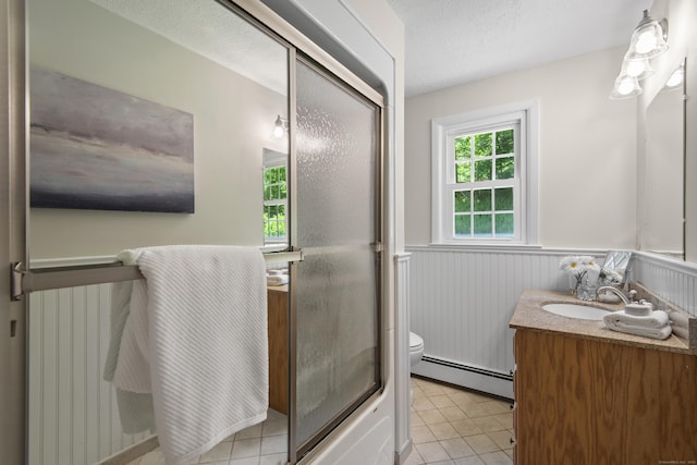 27 Scudder Rd, Newtown, CT 06470 - bathroom with a baseboard radiator, a wainscoted wall, vanity, toilet, and tile patterned floors