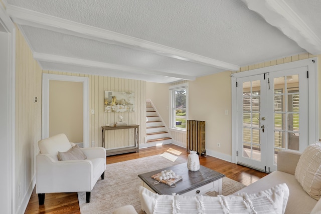 55 Dividend Rd, Rocky Hill, CT 06067 - living area with a textured ceiling, beam ceiling, wood finished floors, stairs, and french doors