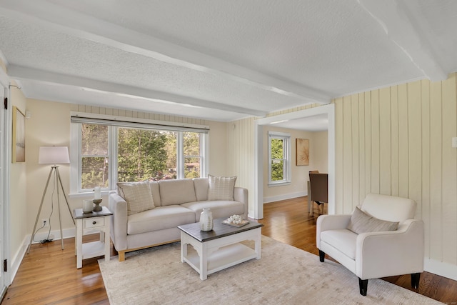 55 Dividend Rd, Rocky Hill, CT 06067 - living area with wood finished floors, a textured ceiling, baseboards, and wood walls