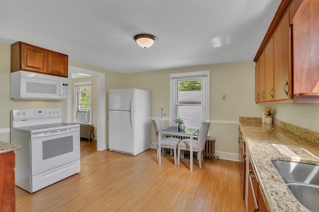 55 Dividend Rd, Rocky Hill, CT 06067 - kitchen with white appliances, light wood finished floors, radiator heating unit, and plenty of natural light