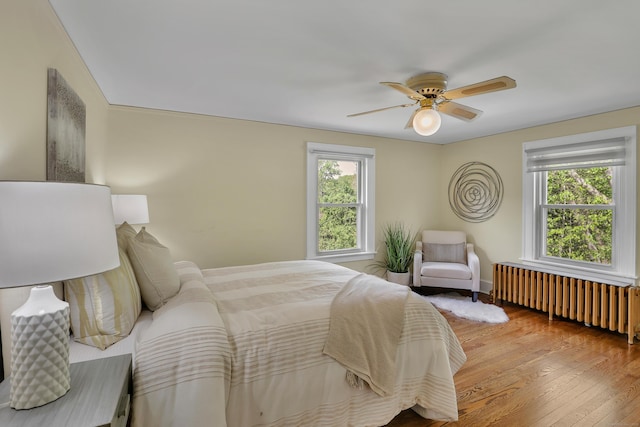 55 Dividend Rd, Rocky Hill, CT 06067 - bedroom with radiator heating unit, wood-type flooring, ceiling fan, and baseboards