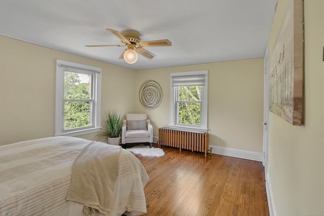 55 Dividend Rd, Rocky Hill, CT 06067 - bedroom featuring radiator, multiple windows, wood-type flooring, and baseboards