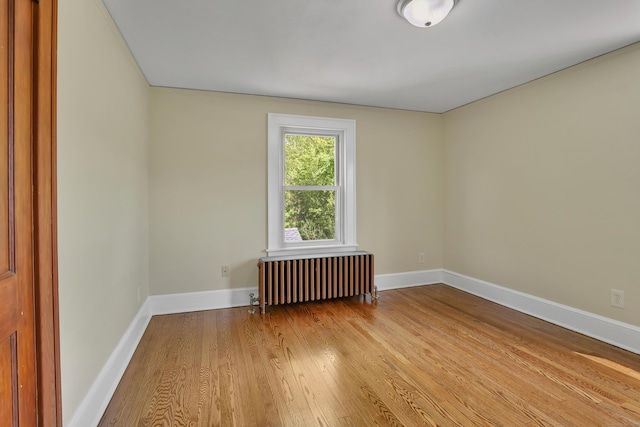55 Dividend Rd, Rocky Hill, CT 06067 - unfurnished room featuring radiator, wood finished floors, and baseboards