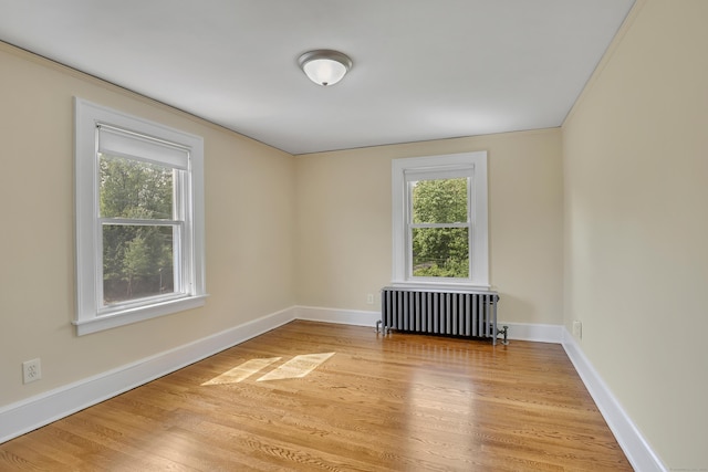 55 Dividend Rd, Rocky Hill, CT 06067 - unfurnished room featuring radiator heating unit, light wood-style flooring, baseboards, and crown molding