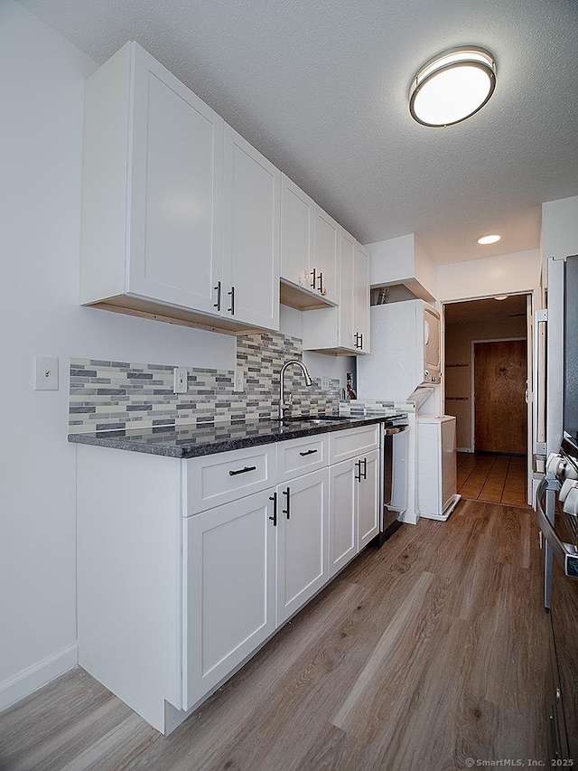 500 Prospect St Apt 3G, New Haven, CT 06511 - kitchen with wood finished floors, a sink, white cabinets, decorative backsplash, and recessed lighting