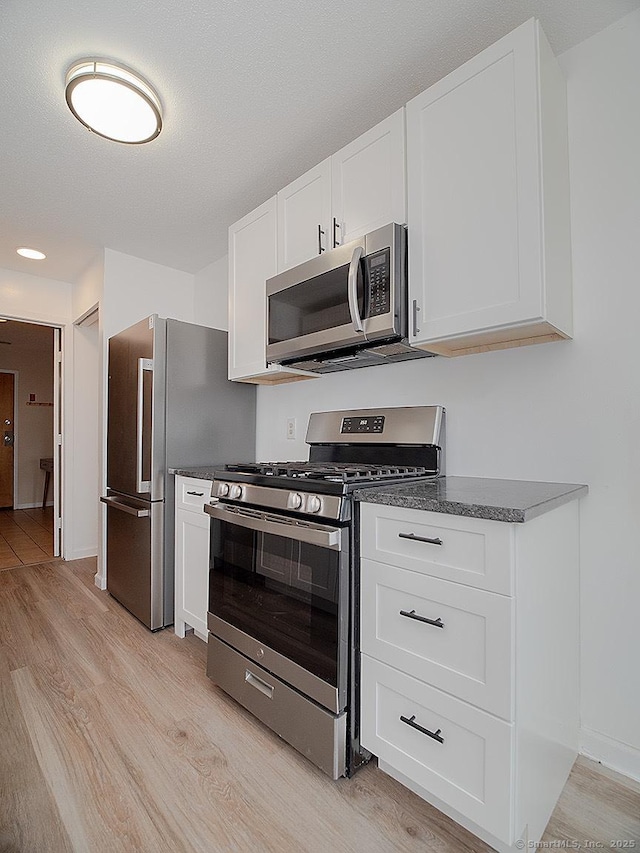 500 Prospect St Apt 3G, New Haven, CT 06511 - kitchen with appliances with stainless steel finishes, light wood-style flooring, white cabinetry, and baseboards