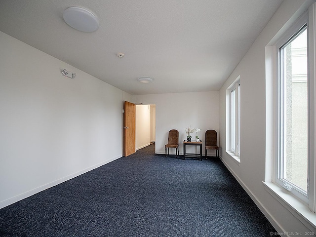 500 Prospect St Apt 3G, New Haven, CT 06511 - unfurnished room with dark colored carpet, healthy amount of natural light, and baseboards