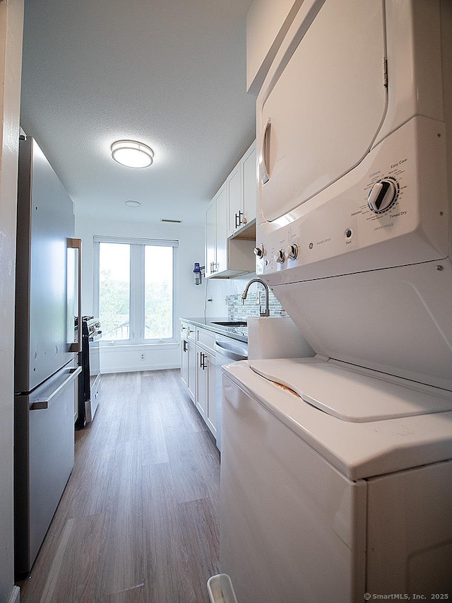 500 Prospect St Apt 3G, New Haven, CT 06511 - laundry area featuring stacked washer / dryer and wood finished floors