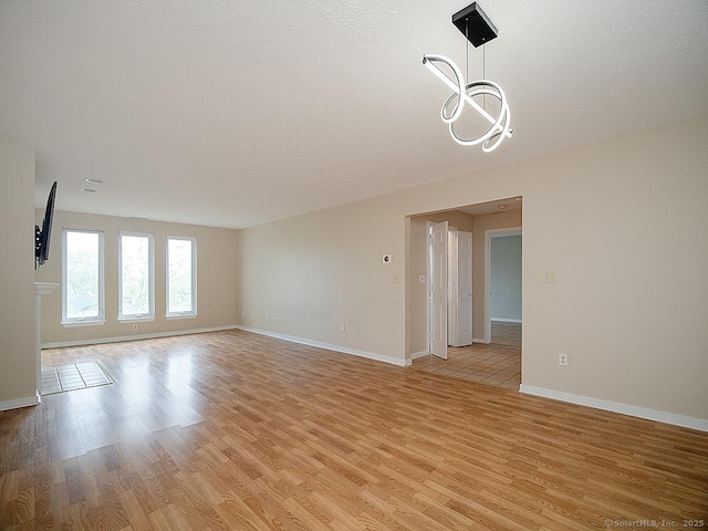 500 Prospect St Apt 3G, New Haven, CT 06511 - unfurnished room featuring light wood-style flooring, a chandelier, and baseboards