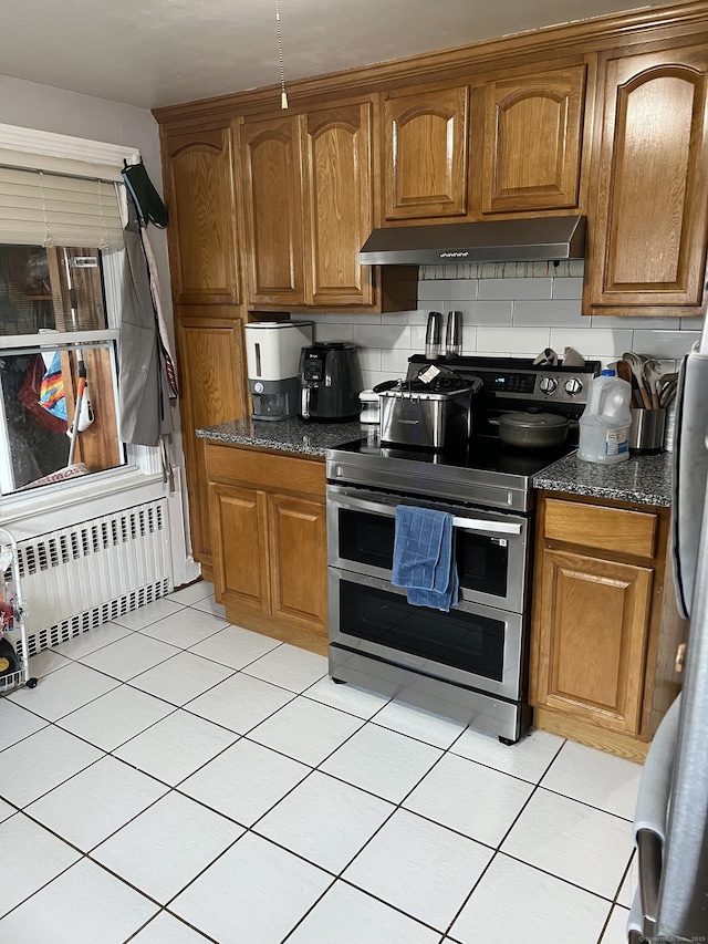 15 Michael Ave, East Hartford, CT 06111 - kitchen with radiator, range with two ovens, under cabinet range hood, and light tile patterned flooring