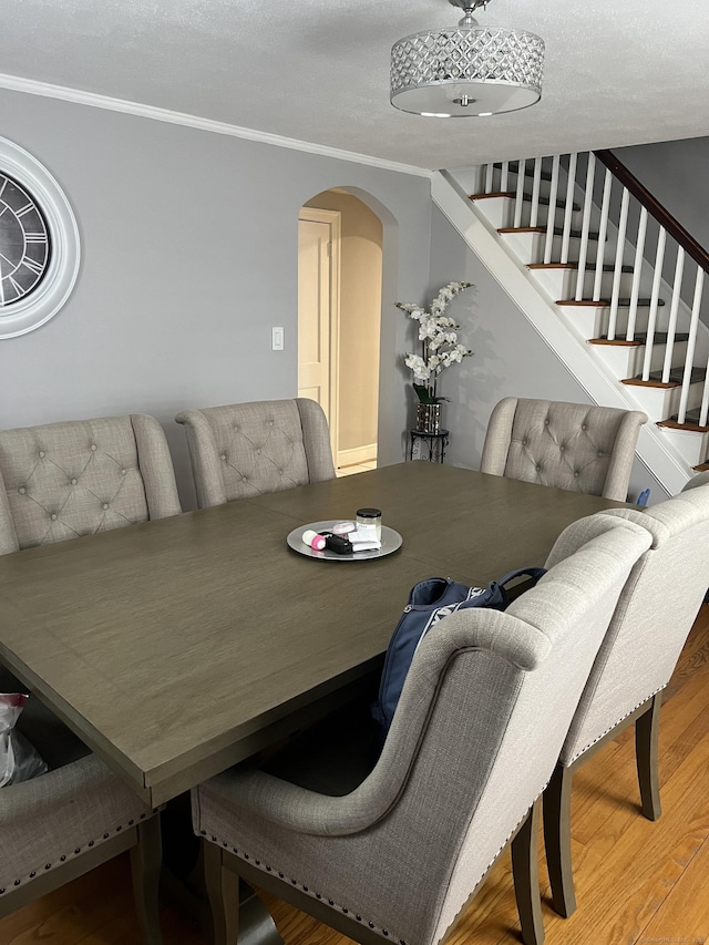 15 Michael Ave, East Hartford, CT 06111 - dining room featuring arched walkways, wood finished floors, crown molding, and stairway