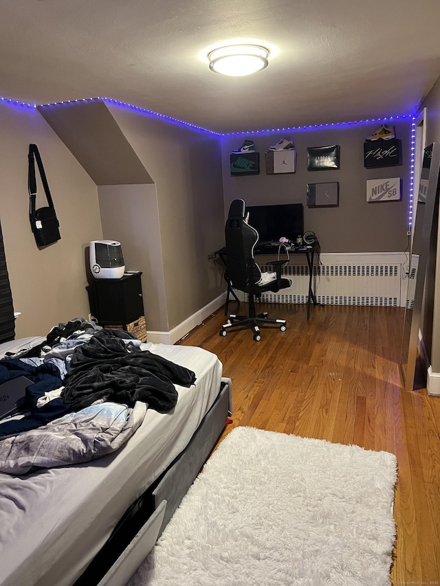 15 Michael Ave, East Hartford, CT 06111 - bedroom featuring radiator heating unit, wood finished floors, and baseboards
