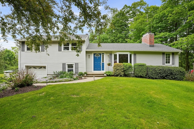 tri-level home featuring a garage, a front yard, and a chimney