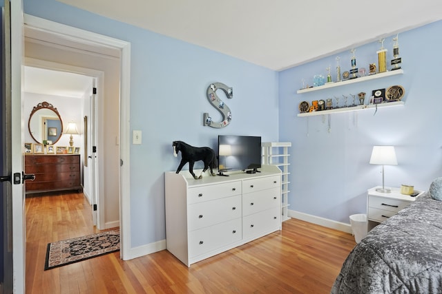 bedroom featuring light wood-style floors and baseboards