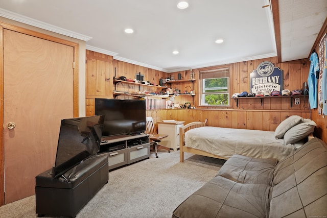 carpeted bedroom with wooden walls, recessed lighting, and crown molding