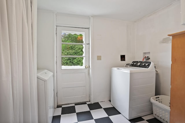 laundry room featuring tile patterned floors and separate washer and dryer