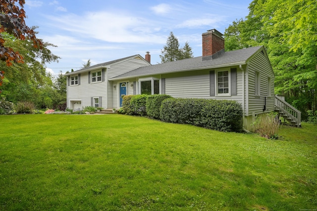 view of front of property with a chimney, a front yard, and stairway