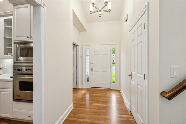 39 Gatewood Unit 39, Avon, CT 06001 - foyer entrance featuring a chandelier, light wood finished floors, and baseboards